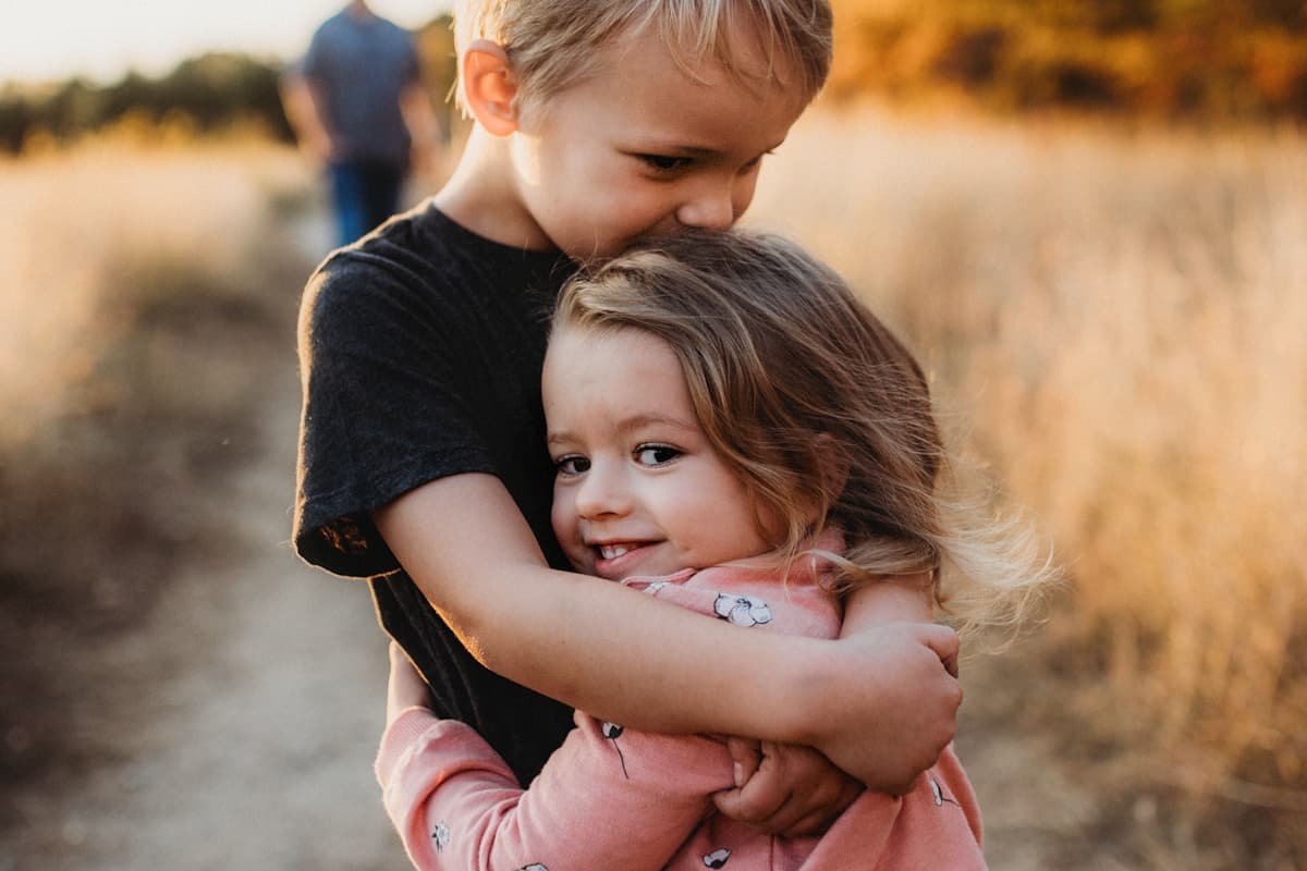 Siblings together, standing in for separate child profiles